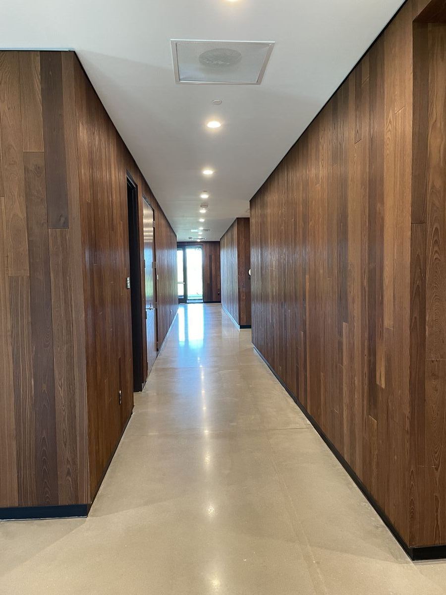 Bandwidth HQ — hallway with wall-to-wall walnut paneling
