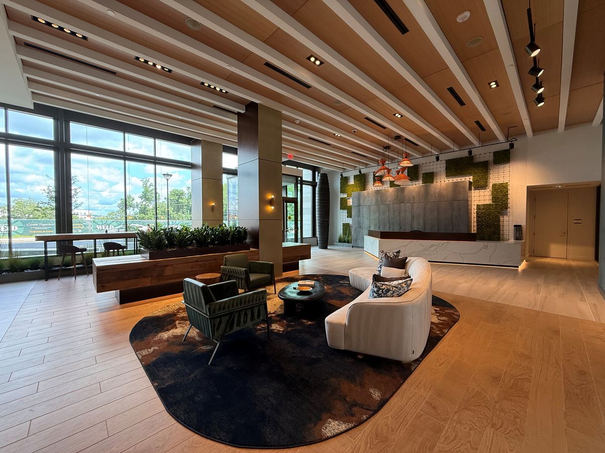 Dix B — luxury lobby with wood ceiling beams and modern furnishings