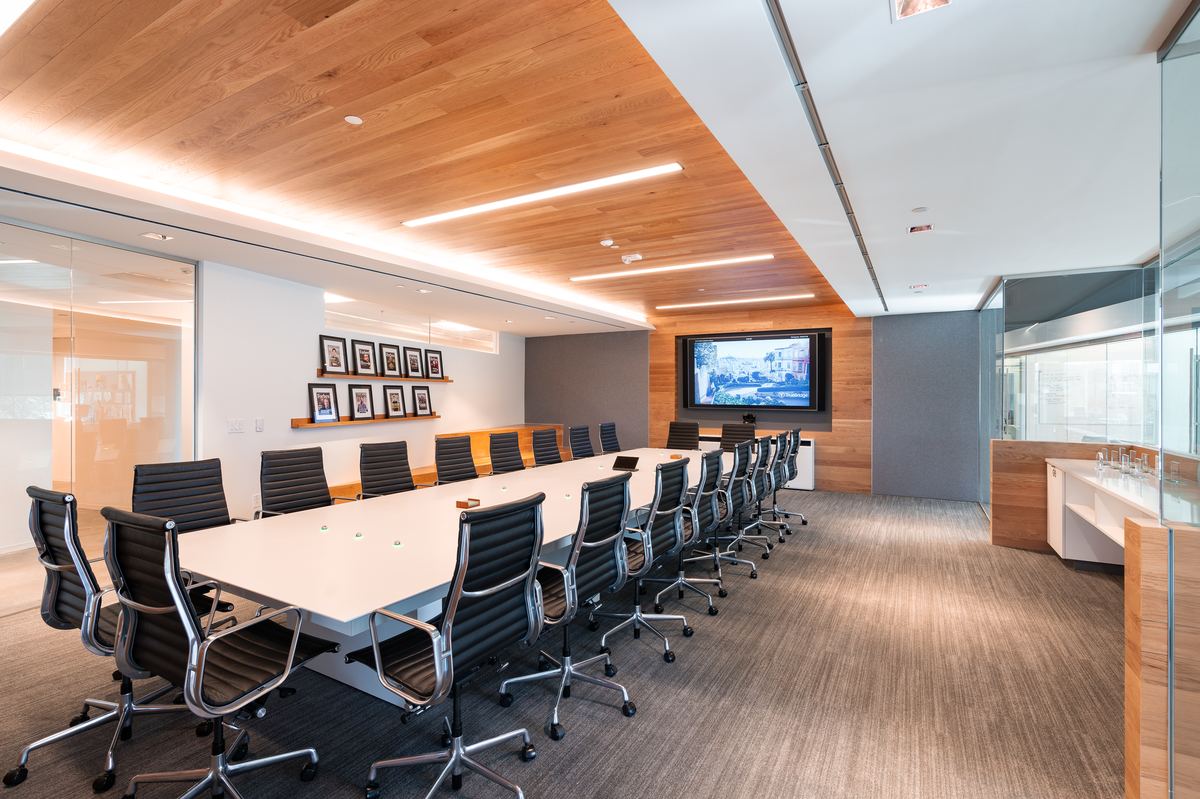 TrueBridge Capital — wood-wrapped boardroom with ceiling panels