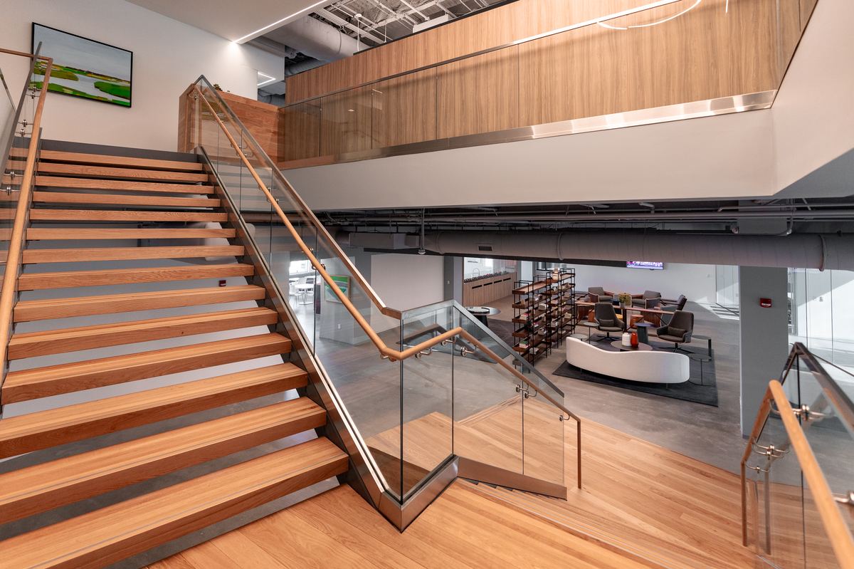 TrueBridge Capital — grand staircase with wood treads and paneling